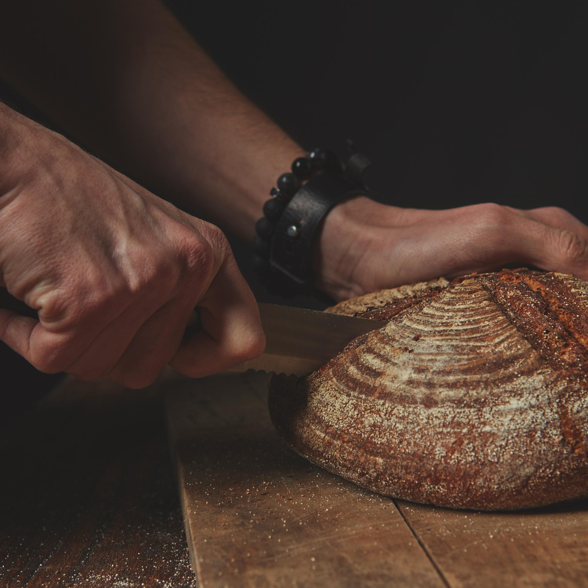 Close-up of artisan bread and hands
